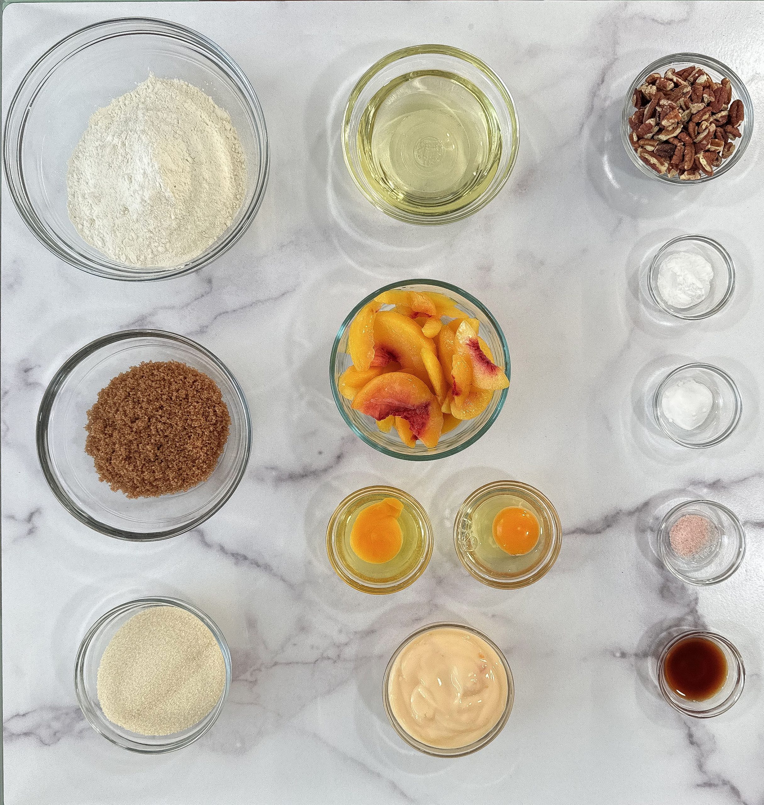 All the ingredients for Peach Yogurt Loaf laid out and ready—simple pantry staples plus ripe peaches and creamy yogurt.